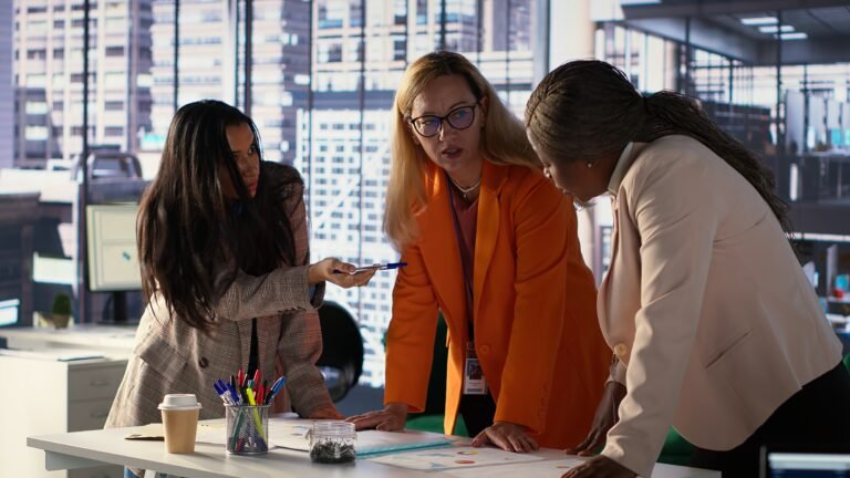 General director reviewing data analytics with team for successful development